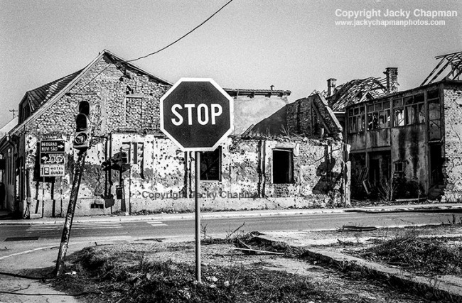 Signs of war are visible in the town, houses remain roofless and in ruins. 1998.